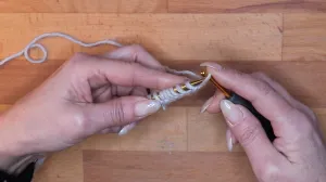 Setze zum Schluss die Schlaufe von der Häkelnadel auf die Stricknadel. Das ist deine letzte Anschlagmasche.. Maschen Anschlagen